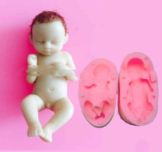 A sleeping baby with his feet up. High-definition silicone mold.