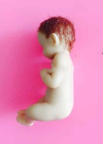 A sleeping baby with his feet up. High-definition silicone mold.