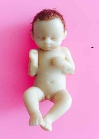 A sleeping baby with his feet up. High-definition silicone mold.