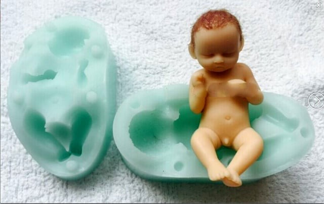 A sleeping baby with his feet up. High-definition silicone mold.