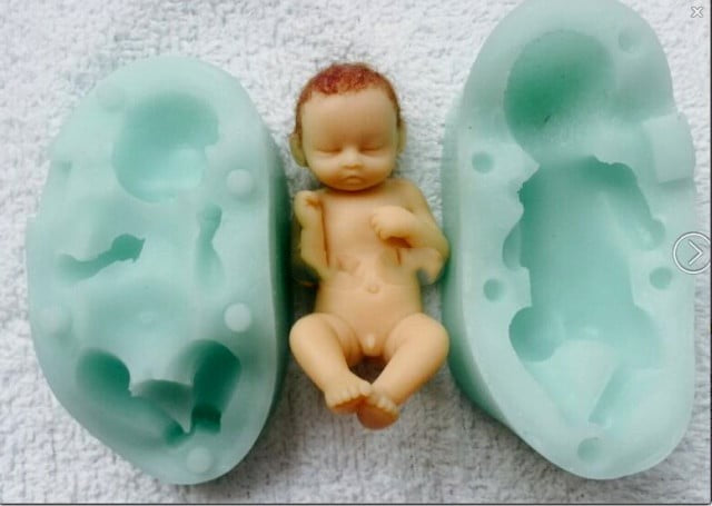 A sleeping baby with his feet up. High-definition silicone mold.